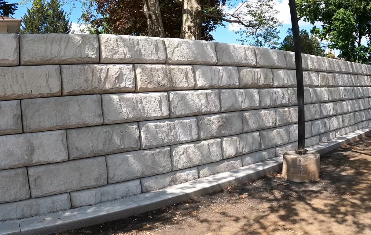 Concrete block retaining wall with professional installation in Crown Point residential property