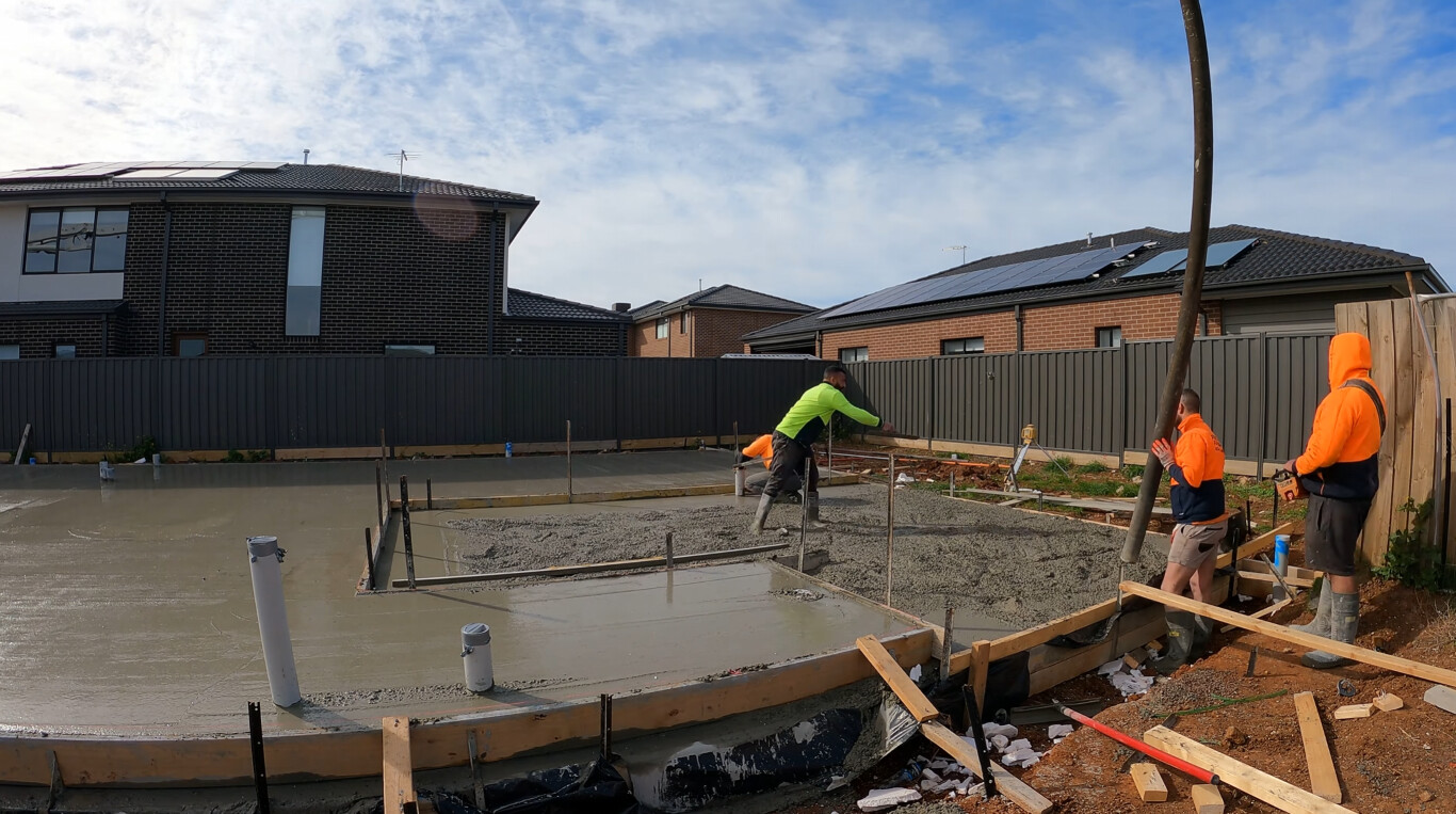 Professional concrete installation crew working on residential slab in Crown Point